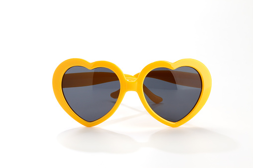 yellow heart-shaped sunglasses isolated on white