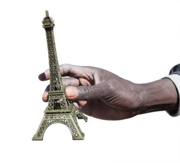 Hand holding Eiffel Tower replica for sale
