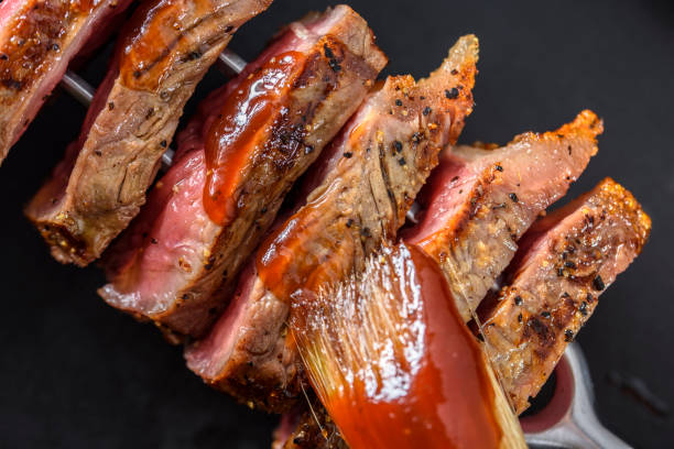 istock Slice of Grilled Steak with BBQ Sauce on a Fork 801600452