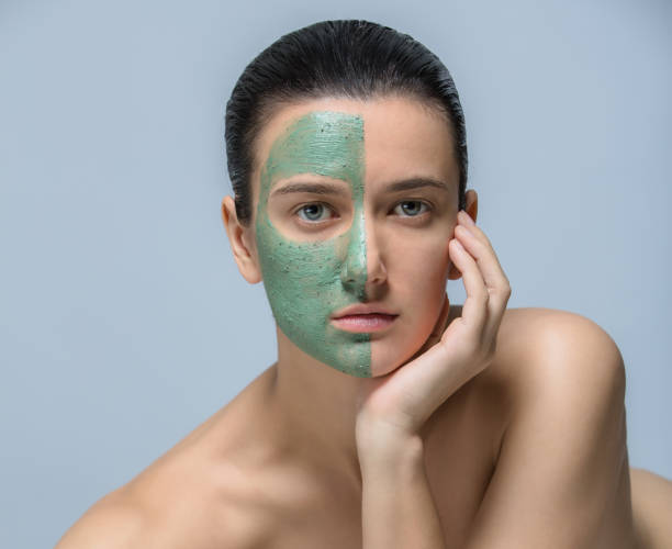 istock Young woman with green face mask - studio portrait 801608016