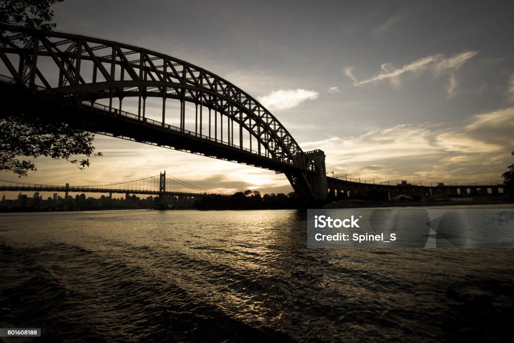 Dark Silhouette of Hell Gate Bridge and Triborough bridge over the river in vintage style, New York Architecture Stock Photo