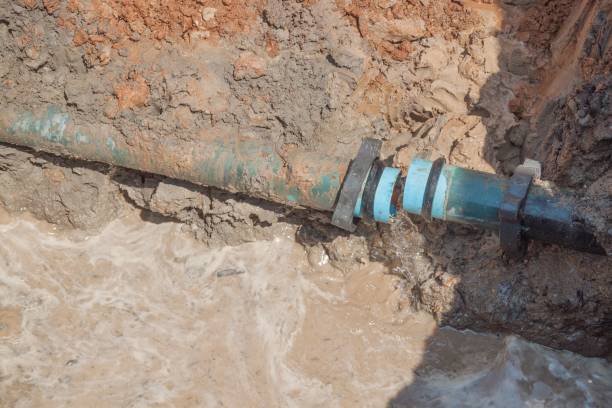 istock plumbing broken  pipe in the hole with water flow 801644978