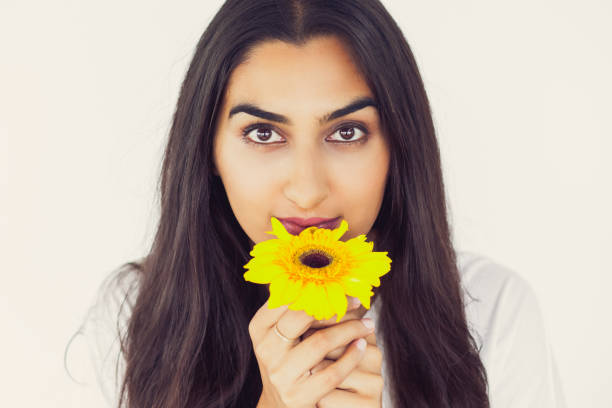 istock Beautiful young woman with yellow flower 801653064