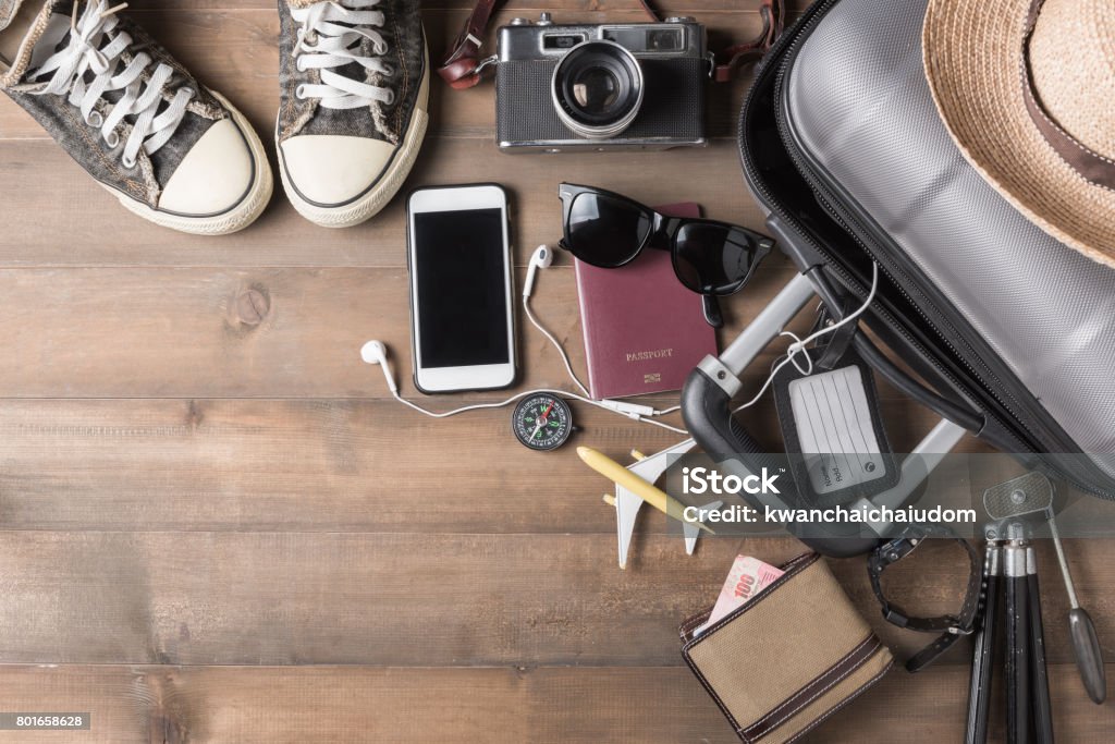 Travel accessories costumes. Passports, luggage Travel accessories costumes. Passports, luggage, camera, sunglasses, boot, sneaker, The cost of travel maps prepared for the trip Suitcase Stock Photo
