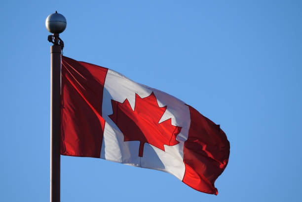 istock Waving Canadian flag against blue sky for celebrating Canada 150 years 801659058