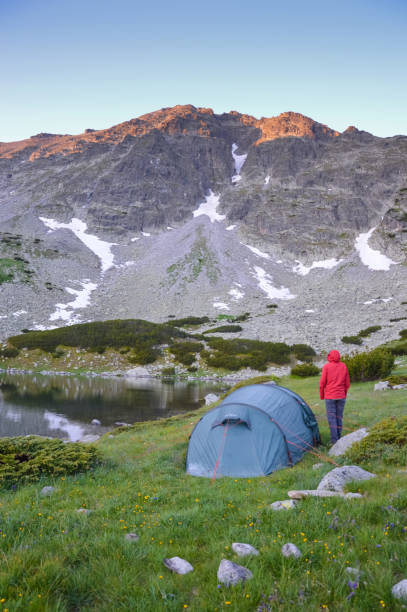 istock Woman and a tent in mountains 801666620