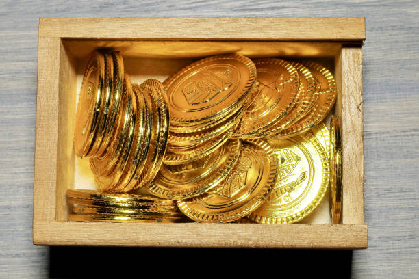 istock Toy gold coins and wood box 801680954