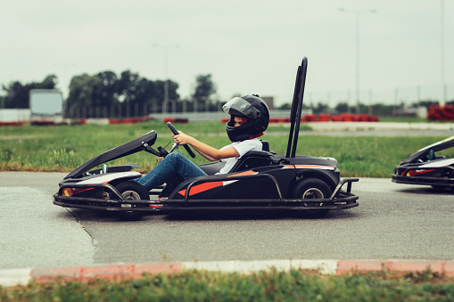 Boy go-Karts. Driving race on driveway.