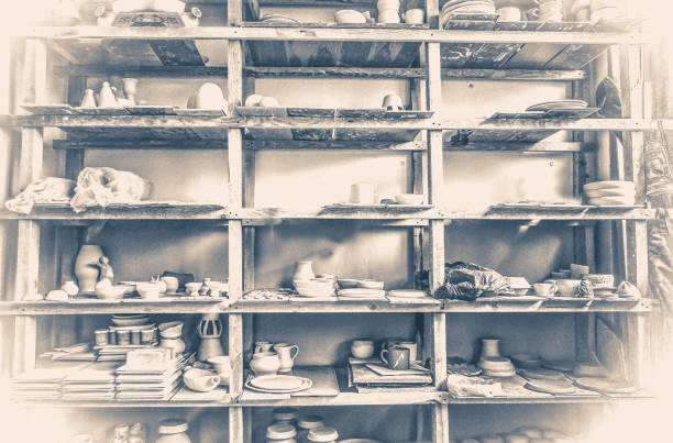 Old vintage photo.racks in a pottery workshop in which there are potter