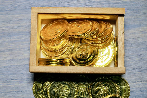 istock Toy gold coins and wood box 801686996