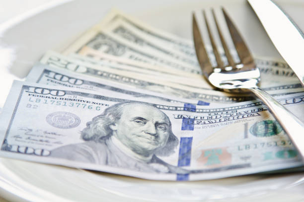 istock American Dollar note on white plate by cutlery 801693750