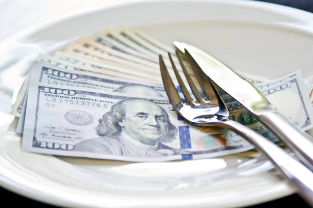istock American Dollar note on white plate by cutlery 801693768