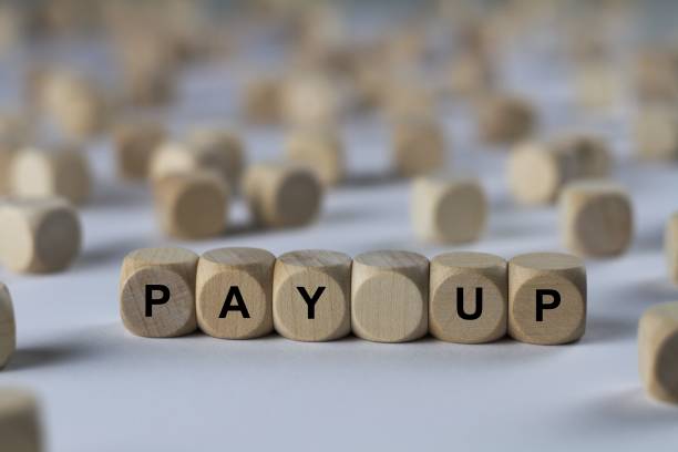 istock pay up - cube with letters, sign with wooden cubes 801704168