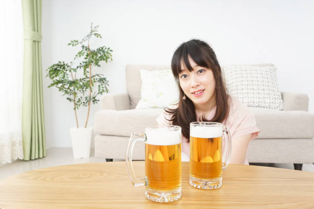 istock Young woman drinking beer 801741790