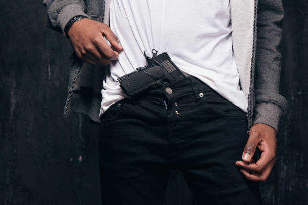 istock Unrecognizable black man threatens with a gun 801747364
