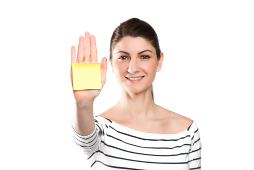 A woman showing a yellow paper on white background