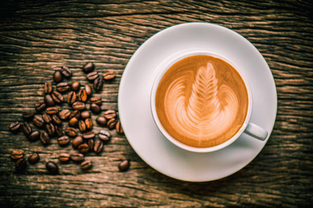istock Coffee cup and coffee beans on wooden background 801780544