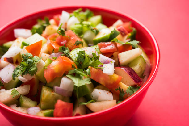 istock Kachumber or indian green salad served in red or white bowl, selective focus 801783840
