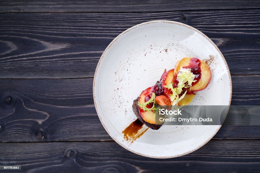 Goose liver with cherry sauce and apples Food Stock Photo