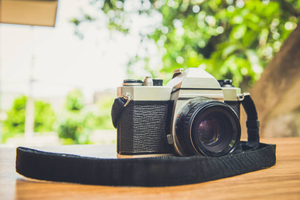 istock Vintage camera on wooden table 801791566