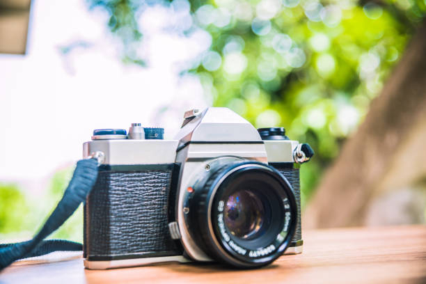 istock Vintage camera on wooden table 801791672