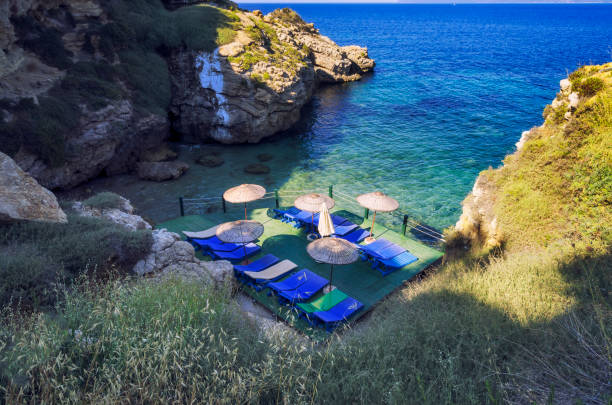 istock Sunshades and chaise lounges on beach 801815690