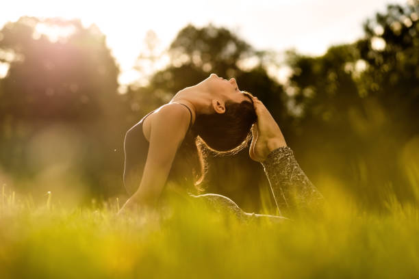 istock yoga woman on green park 801821580