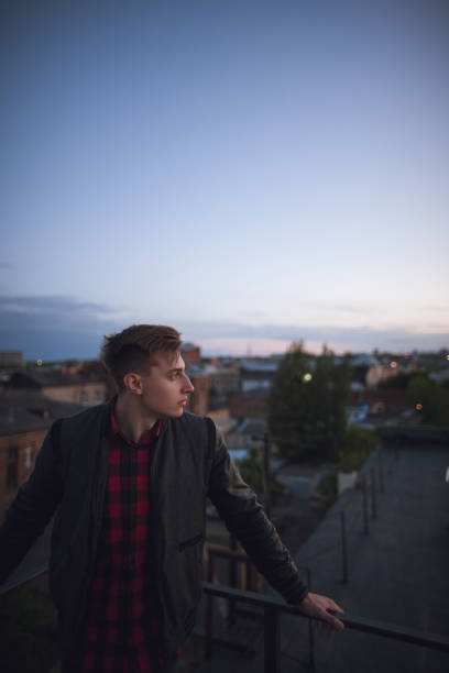 istock Portrait of handsome man on night sky background 801830606