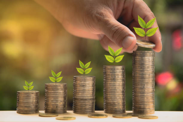 istock Saving money concept and hand putting money coin stack growing for business 801840456