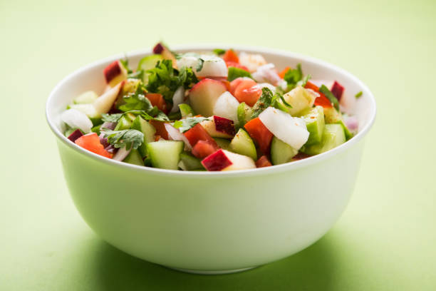 istock Kachumber or indian green salad served in red or white bowl, selective focus 801840732