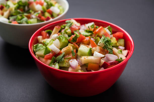istock Kachumber or indian green salad served in red or white bowl, selective focus 801852906