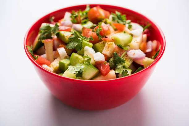 istock Kachumber or indian green salad served in red or white bowl, selective focus 801853498