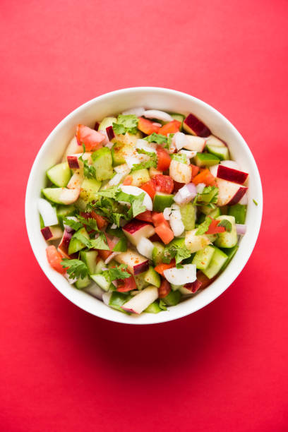 istock Kachumber or indian green salad served in red or white bowl, selective focus 801859644
