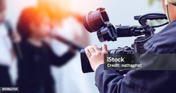 Video Camera Operator Working With His Equipment Stock Photo - Download Image Now - Camera Operator, Movie, Industry