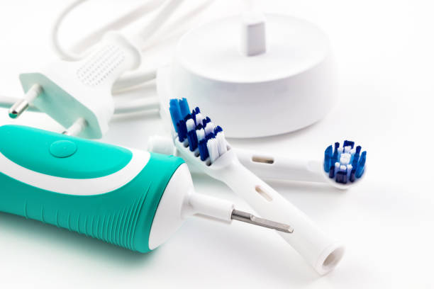 istock soft focus toothbrush electric, Dental care tools on white background. 801874358