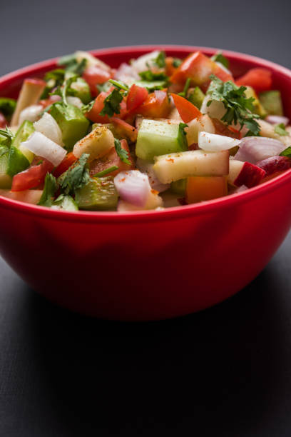 istock Kachumber or indian green salad served in red or white bowl, selective focus 801874554