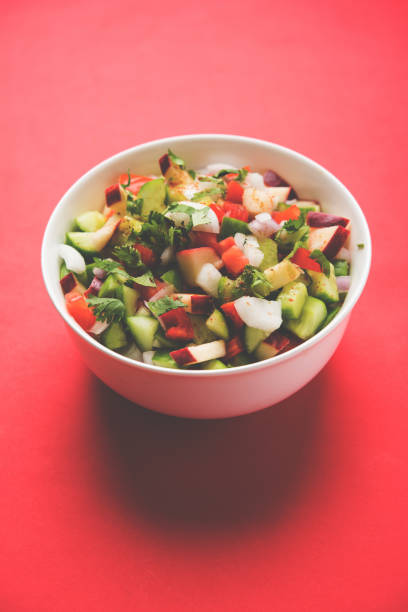 istock Kachumber or indian green salad served in red or white bowl, selective focus 801878148