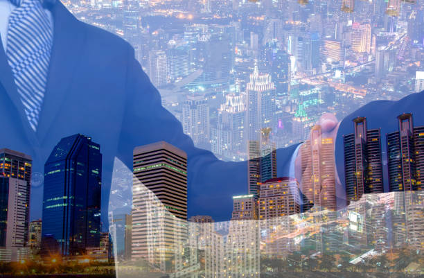 istock business handshake with city background, Double exposure style 801882060