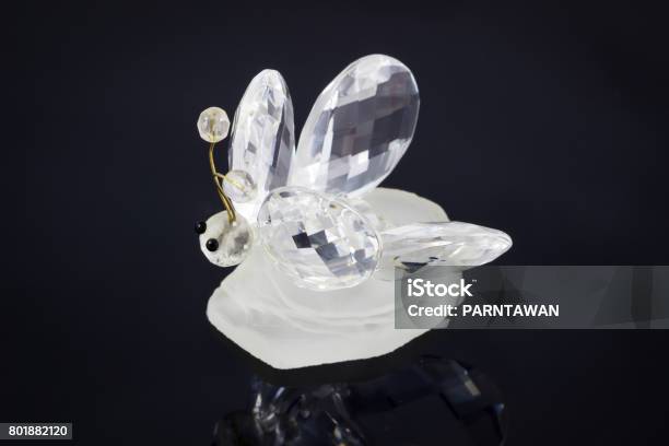 Crystal Bee Animal On Black Satin Background Souvenir In The Form Of Crystal Bee With Reflection From A Metal Ridge Surface Is Visible Stock Photo - Download Image Now