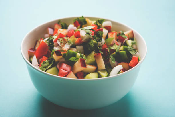 istock Kachumber or indian green salad served in red or white bowl, selective focus 801889176