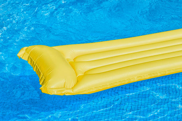 istock Yellow air mattress floating in a swimming pool. 801889614