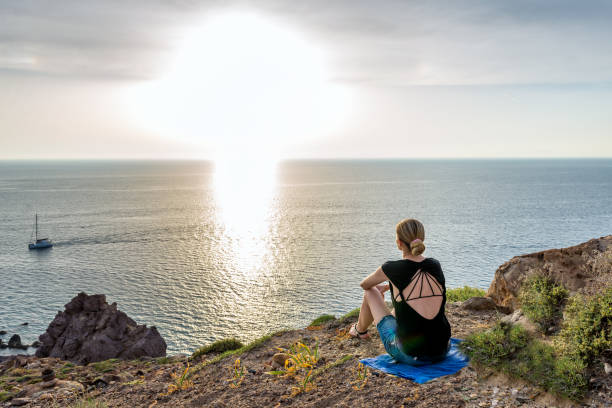 istock Young woman watching sunset 801892540