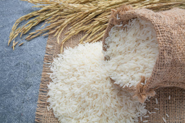 istock thai fragrant jasmine rice in a spoon with gold spike on Sack 801892618