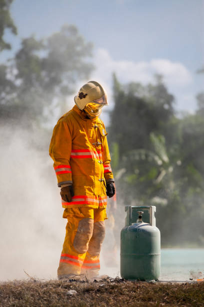 istock Firefighter with fire and suit for protect fire fighter for training firefighters. 801892962