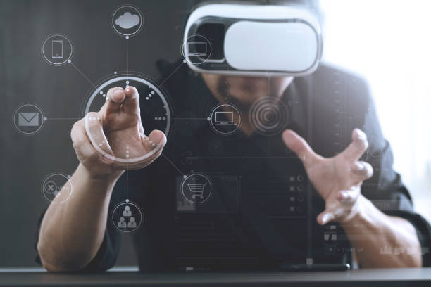 istock businessman wearing virtual reality goggles in modern office with Smartphone using with VR headset 801895334