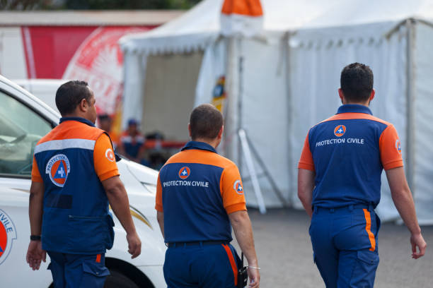 Protection Civile in patrol Saint-Gilles les bains, La Réunion - June 25 2017: Three officers of the "Protection Civile" (First Responder) on patrol during the carnival of the Grand Boucan. french civil protection stock pictures, royalty-free photos & images