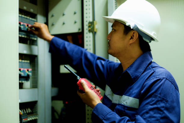 istock Engineer turning on switch in the electrical cabinet at control room with selective focus 801931670