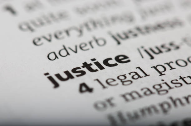 istock Word justice printed and defined in a English dictionary 801947986