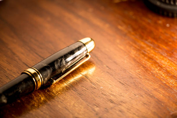 Fancy pen A fancy pen on a wooden table documento stock pictures, royalty-free photos & images