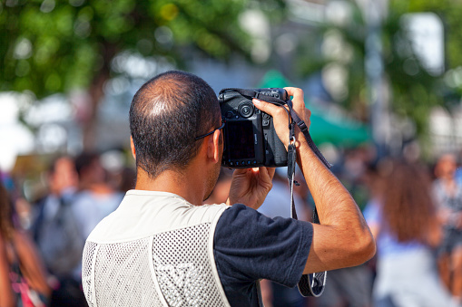 Saint-Gilles les bains, La Réunion - June 25 2017: Reporter taking a picture of the crowd during the carnival of the Grand Boucan.